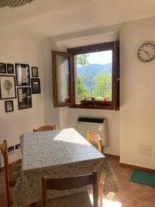 a dining room with a table and a window at Casa nella natura a Bobbio in Bobbio