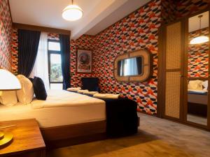 a bedroom with a bed and a mirror at 74 Museum Hotel in Antalya