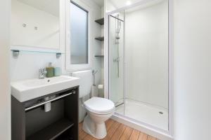 a bathroom with a toilet and a sink and a shower at Mobile home MAŠA 163, camp Porton Biondi in Rovinj
