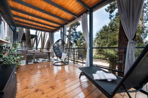 a living room with a wooden floor and large windows at Mobile home MAŠA 163, camp Porton Biondi in Rovinj