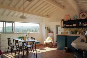 a kitchen with a table and chairs in a room at Casa Julia, maison familiale in Forcalquier +15 photos