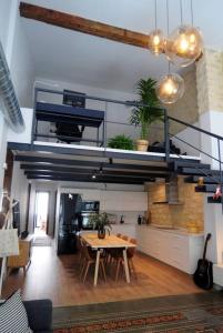 a living room with a table and a loft at Duplex en el centro de Alicante in Alicante