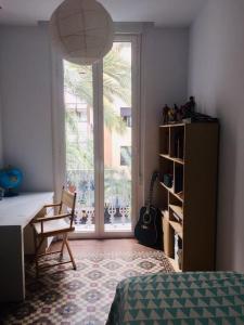 a room with a bed and a desk and a window at Duplex en el centro de Alicante in Alicante