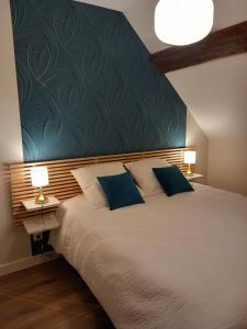 a bedroom with a large bed with a blue wall at Room in Guest room - Decouvrez un sejour relaxant a Meursault, en France in Meursault