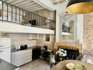 a kitchen with a staircase and a living room at Le Lion des Ducs : centre historique de Dijon in Dijon