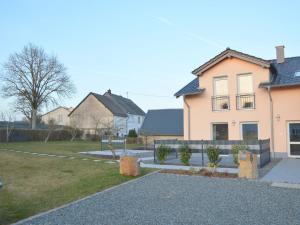 a house with a fence in front of a yard at Dreamy Holiday Home in Ellscheid with Terrace in Ellscheid