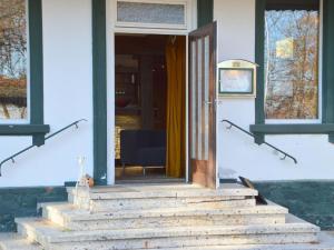 a front door of a house with a chair at Pleasant Holiday Home in Kemmenau with Sauna in Kemmenau