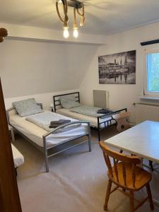 een kamer met 2 bedden, een tafel en een eetkamer bij Wohnung Apartments Beny in Bad Bellingen