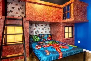 a bedroom with a superhero themed bunk bed at Family Resort - 12BR Mansion - Sleeps 28 - Private Pool, BBQ and Games Room! in Kissimmee