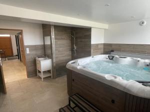 a large bathroom with a large tub with a sink at Gite des 5V in Gerbépal +15 photos