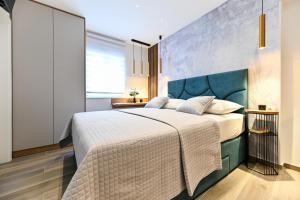 Posteľ alebo postele v izbe v ubytovaní Apartments and Rooms Nekic
