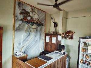 an office with a desk and a painting on the wall at Hotel GD Stay Inn Near Mahura Chhak in Bhubaneshwar