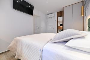 Posteľ alebo postele v izbe v ubytovaní Apartments and Rooms Nekic