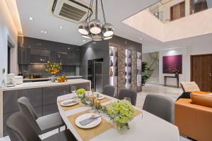 a kitchen and living room with a table and chairs at Penthouse Duplex 4 bedrooms Ocean View in Danang +22 photos