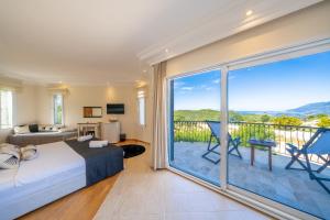 a bedroom with a bed and a balcony with a view at LaCitrus Villa Hotel in Kas
