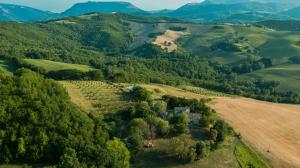 an aerial view of a farm in the hills at Agriturismo Il Fienile di Cà Battista in Cagli