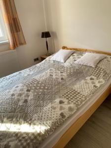 a bedroom with a large bed with a wooden frame at Netti Ferienhaus in Marcali
