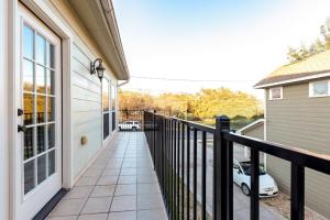 a balcony with a black railing next to a house at East Austin Family Home - 5 mins from downtown in Austin