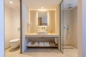 a bathroom with a sink and a shower at Tsamis Zante Suites in Kipseli