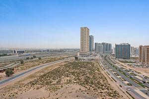 a view of a city with a highway and buildings at Charming and Spacious Studio in Dubai