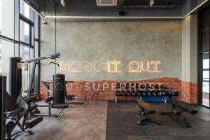 a gym with exercise equipment on a brick wall at Millerz Square Tower E Near MidValley by YourSuperhost in Kuala Lumpur