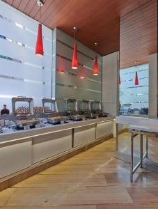 a fast food restaurant with red lights above a counter at Hotel Residency Andheri in Mumbai