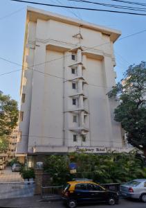 a building with a car parked in front of it at Hotel Residency Andheri in Mumbai