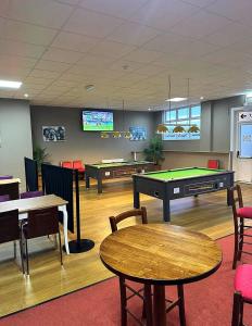 a room with a pool table and ping pong tables at Sheepy village Leysdown in Leysdown-on-Sea