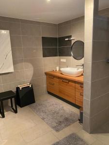 a bathroom with a sink and a mirror at Gästehaus LuNa in Zeil