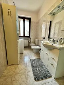 a bathroom with a sink and a toilet and a shower at Civico 56 in Verona