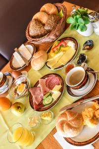 a table topped with plates of food and bread at Hotel Lärchenhof in Lermoos