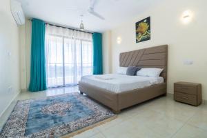 a bedroom with a bed and a large window at Mombasa Nyali Beachfront Apt in Mombasa +28 photos
