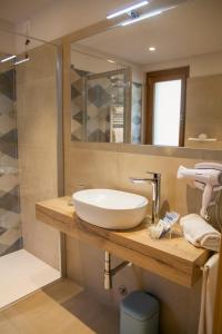 a bathroom with a sink and a shower at Albergo La Romanella in Spinone Al Lago