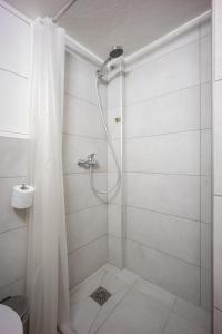 a shower with a shower curtain in a bathroom at Acropolis Delux 1st FLR Aprt up 4 guests by LODGESPOT in Athens