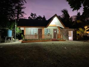a small house with a night view at Ati Lodge Boracay in Boracay