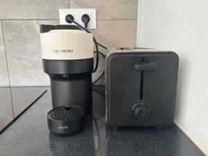 a coffee maker and a blender next to a wall at Canyelles BBQ Apartment in Lloret de Mar