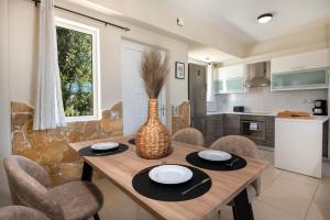 a kitchen and dining room with a wooden table and chairs at Gabriel apartment with a shared pool close to the beach in Chorafakia