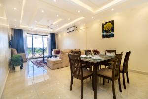 a dining room and living room with a table and chairs at Mombasa Nyali Beachfront Apt in Mombasa