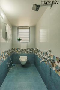 a bathroom with a toilet and a sink at EKOSTAY - Forestwood Villa in Alibaug +12 photos