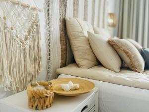 a table with a plate on top of a couch at KAI Apartment Playa Paraiso in Playa Paraiso +31 photos