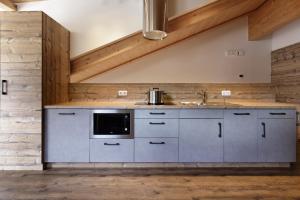 a kitchen with a sink and a microwave at Dolomite Apartments - by Familiaris in San Candido +73 photos