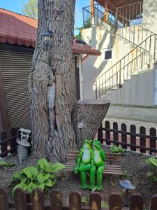 two green hulk figurines standing next to a tree at Casa Ancuta in Eforie Sud +9 photos