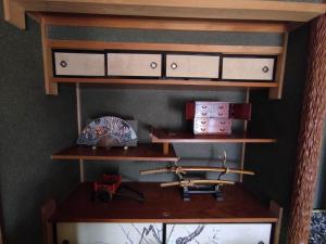 a room with wooden shelves with weapons on it at One person Random room Local house stay- Vacation STAY 40532v in Hida