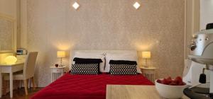 a bedroom with a red bed with two pillows at Apartment Medea 2 with private parking in Opatija