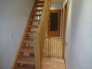 a staircase with wooden steps in a room at Ferienwohnung auf dem Lande in Loxstedt