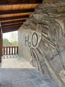 a stone wall with the word hog written on it at Готель-ресторан "Колиба" in Brody