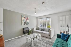 a living room with a couch and a table at Hidden Safari home in Canterbury with free parking in Kent