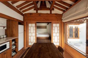 a dining room with a table and a bed at Luxury hanok with private bathtub -SN15 in Seoul