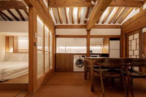 a bedroom with a bed and a table and chairs at Luxury hanok with private bathtub -SN15 in Seoul