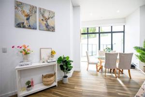 a living room with a table and chairs and a dining room at Cozy Retreat in Sydney CBD in Sydney